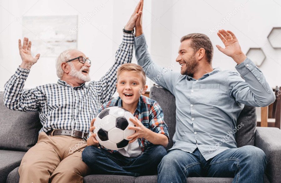 grandfather father & son watch soccer match